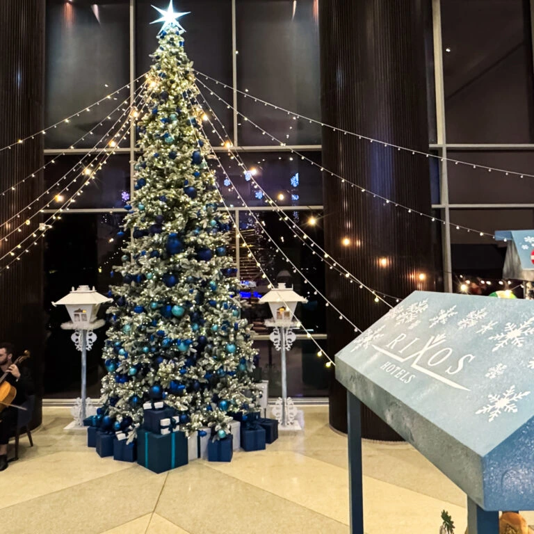 Order blue and silver Christmas tree décor with gift boxes for hotels and resorts.