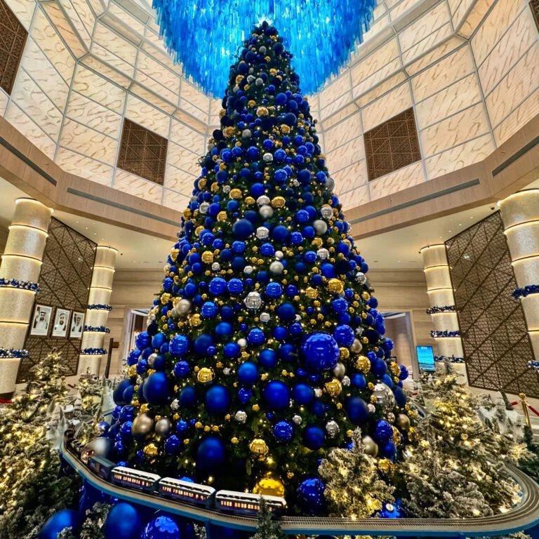 Giant Christmas tree with blue and gold ornaments – rent luxury holiday decoration services.