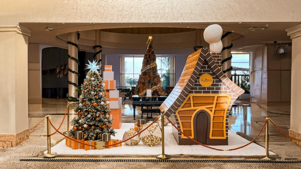Best gingerbread house and luxury Christmas tree display inside resort lobby.