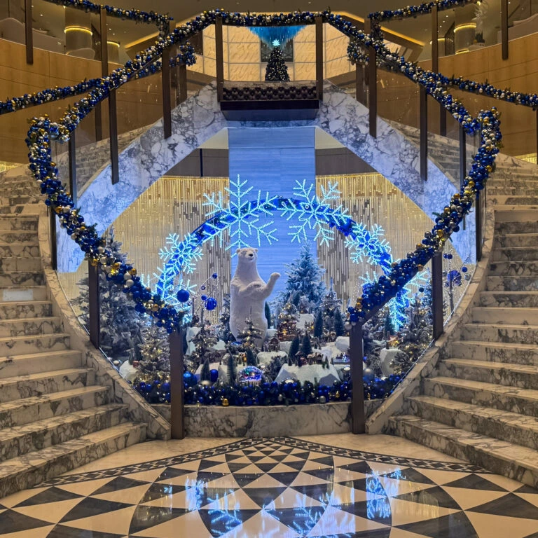 Book luxury polar bear Christmas display with snowflake arch and festive trees for hotel décor.