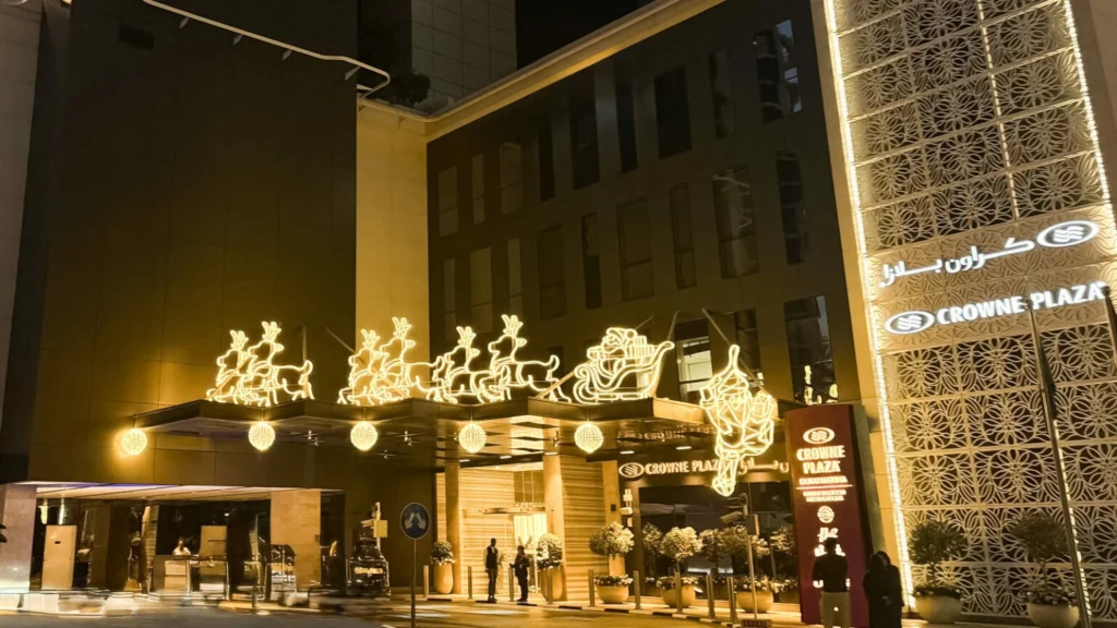 Best Crowne Plaza hotel entrance with glowing Santa sleigh and reindeer Christmas lights.