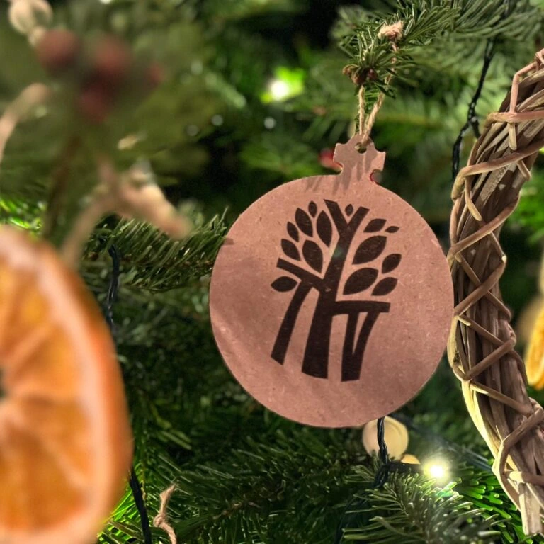 Best eco-friendly Christmas ornament with tree logo on luxury holiday tree.