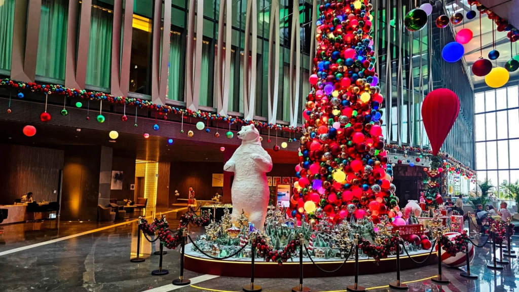 Best luxury hotel lobby Christmas display with giant polar bear and colorful festive tree.