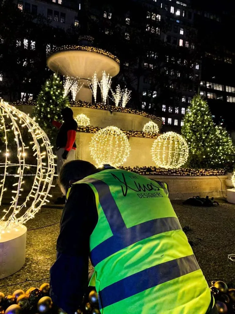 Book professional outdoor Christmas decoration service with lighted spheres and gold ornaments by The Xmas Designers.