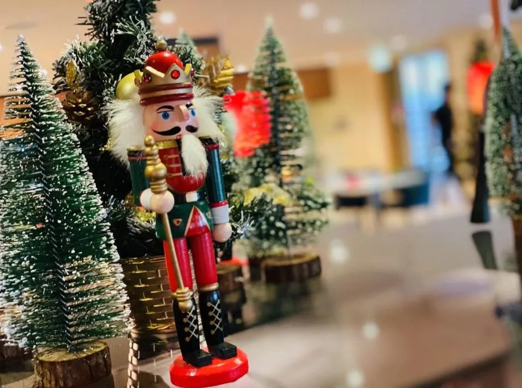 Premium Christmas decoration setup featuring matte black reindeer, gold-accented ornaments, and miniature trees, reflecting elegant and contemporary holiday styling.